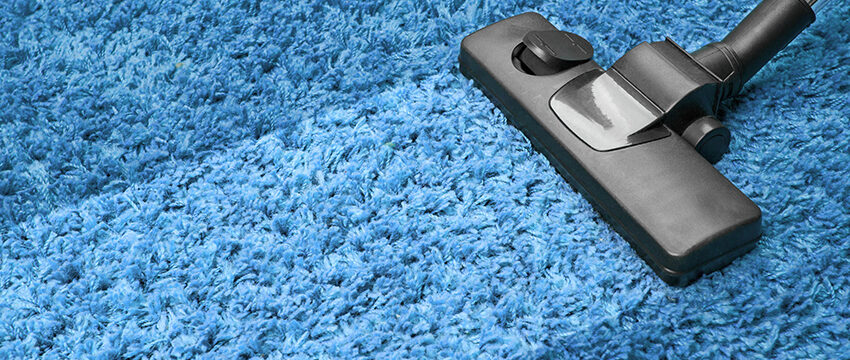 A carpet cleaning machine is on the floor.