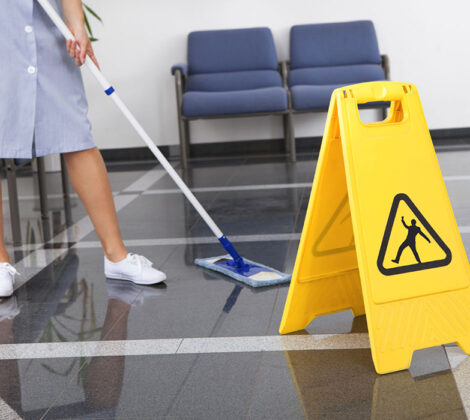 A person cleaning the floor with a mop